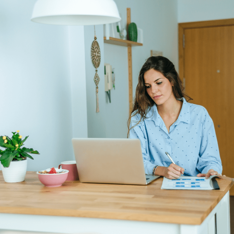 Young woman working at laptop from home
